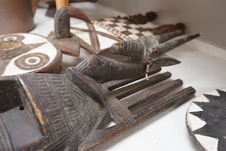 Three African tribal masks and a carved folding tray, largest 92cm. Condition - fair to good